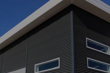 Siding panels for metal structures