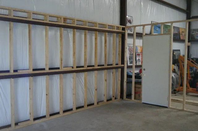 Interior framing a steel building with lumber studs
