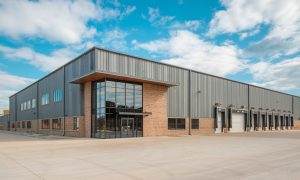 10,000 Sq Ft prefab steel warehouse with brick accents, glass entry, loading docks, and a modern industrial design located in Tampa Florida