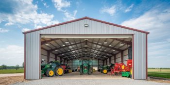 Commercial farm steel building, 5,000 Sq Ft, housing farm machinery and equipment, featuring a steel frame and high-clearance gable roof