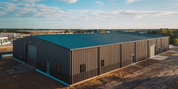 6,000 Sq Ft Industrial PEMB structure, multiple entry points, set on a commercial lot near New Orleans