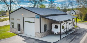 22x30 steel building workshop with an attached RV shelter canopy lean-to in a residential area