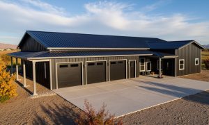 Modern barndominium with attached three car garage in black