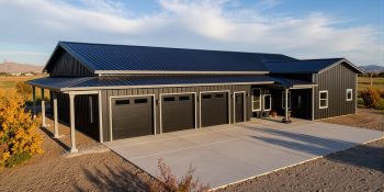 Modern barndominium with attached three car garage in black