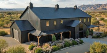 Aerial view of a large two story 7,000 sq ft barndominium in charcoal gray and black