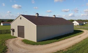 Prefab drive-through barn building in beige and brown