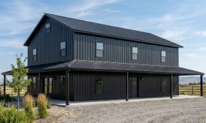 Black on black barndominium with wrap around deck