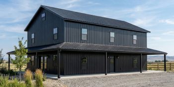 Black on black barndominium with wrap around deck