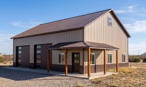 30x40 shop with loft, two vehicle bays and a wrap around porch finished in brown and beige.