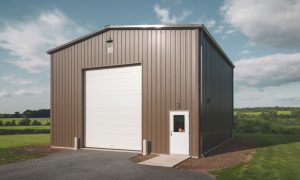 30x30 metal building in brown and white with one overhead garage door and one walk door