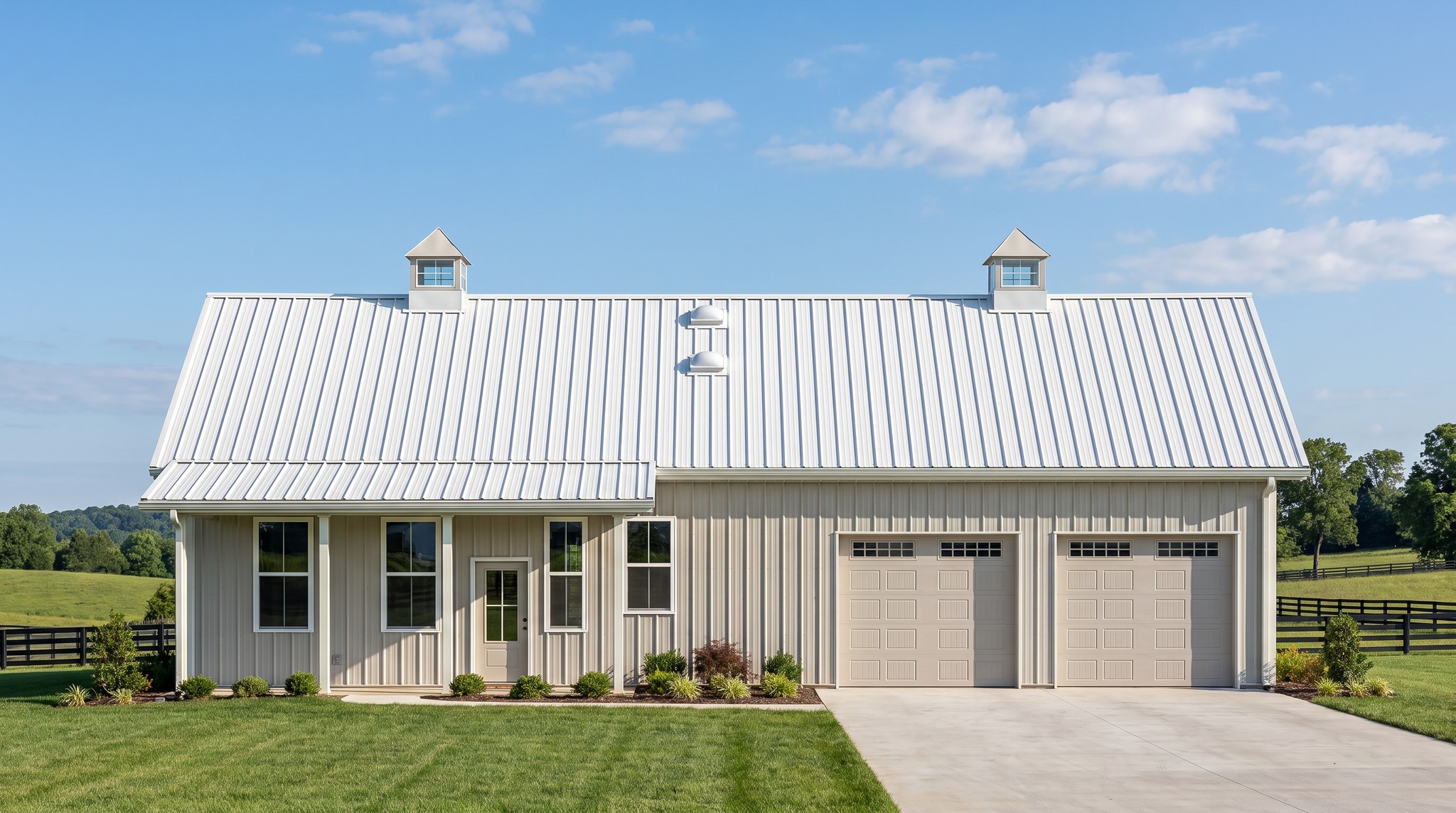 The Meadow 40×60 barndominium front elevation (south on the plan), photoreal render: 6:12 gable, the 24 foot front porch, two cupolas and two overhead doors into the 2-car garage